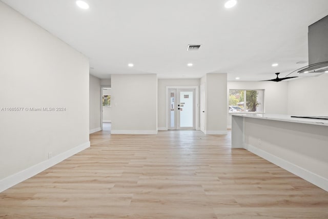 interior space featuring french doors, light wood-type flooring, and ceiling fan