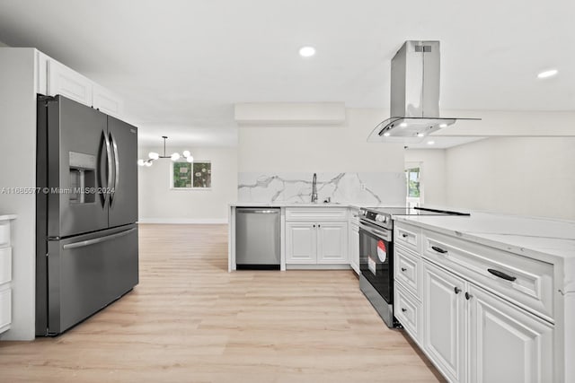 1410 NW 56th Ave, Lauderhill, FL 33313 - kitchen featuring stainless steel appliances, island exhaust hood, white cabinets, plenty of natural light, and recessed lighting