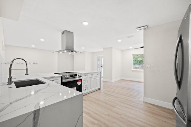 kitchen with island exhaust hood, light stone counters, white cabinetry, sink, and stainless steel appliances