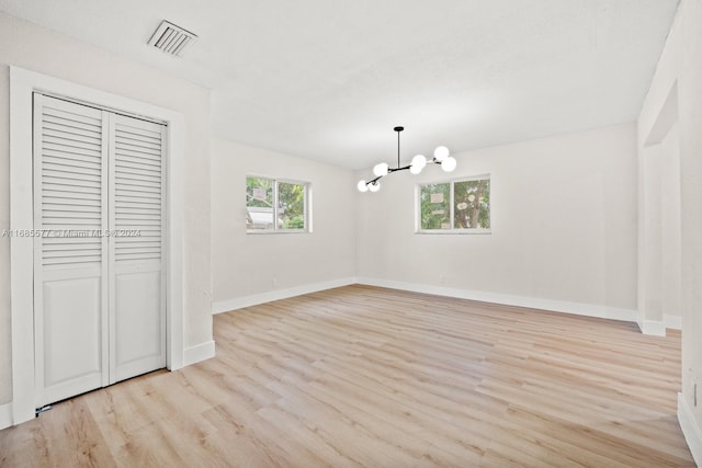 unfurnished dining area with light hardwood / wood-style flooring and an inviting chandelier