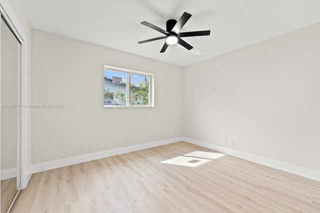 unfurnished bedroom with light hardwood / wood-style flooring, a closet, and ceiling fan