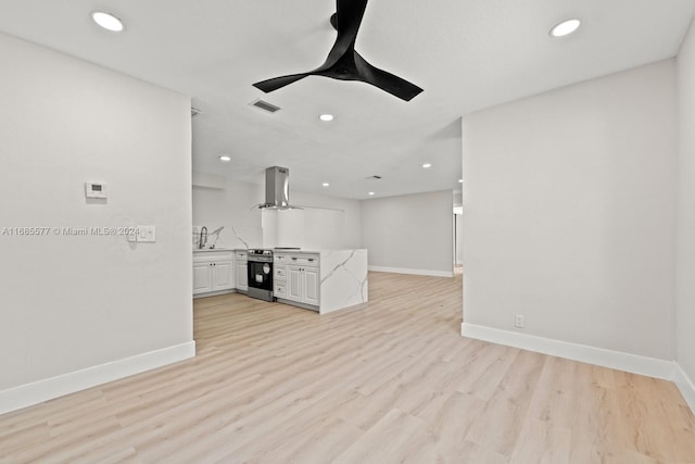 unfurnished living room with sink and light wood-type flooring