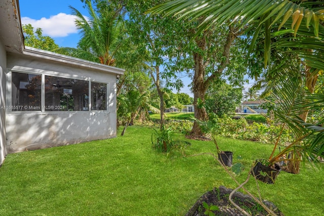 view of yard with a sunroom