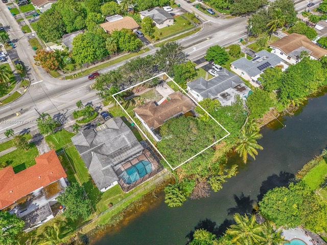 1410 NW 56th Ave, Lauderhill, FL 33313 - aerial view of property and surrounding area with property boundaries highlighted, a large body of water, and nearby suburban area