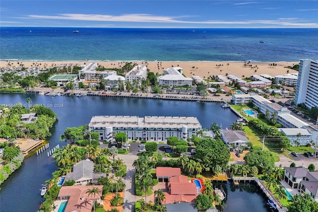 drone / aerial view featuring a beach view and a water view