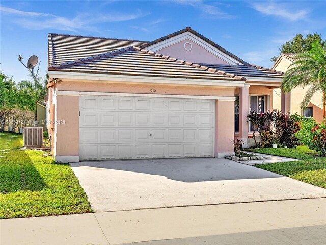 single story home featuring central AC, a garage, and a front lawn