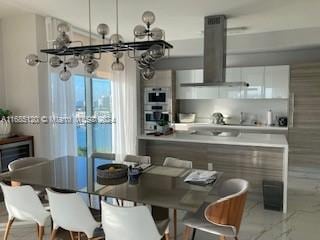 kitchen featuring white cabinetry, black stovetop, and ventilation hood