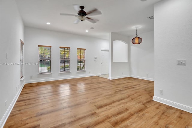 unfurnished living room featuring ceiling fan and light hardwood / wood-style flooring