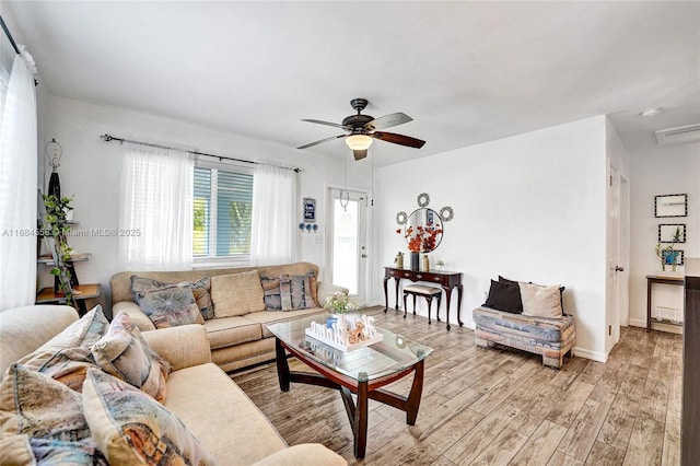 living room featuring ceiling fan and light wood-type flooring