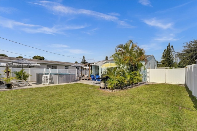 view of yard with a fenced in pool and a patio