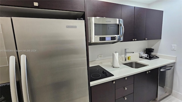 kitchen featuring sink, light tile patterned flooring, and stainless steel appliances