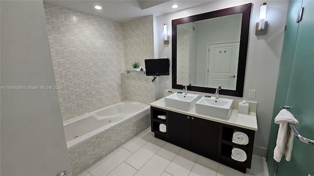 bathroom with vanity, tile patterned flooring, and tiled tub