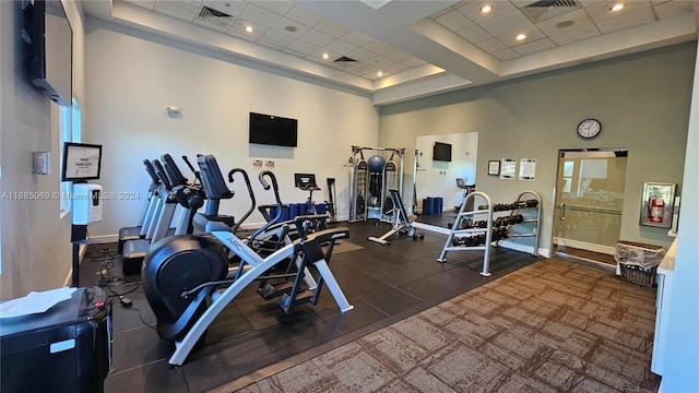 exercise room featuring a high ceiling