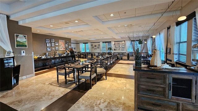 dining room featuring beam ceiling, coffered ceiling, and light hardwood / wood-style floors