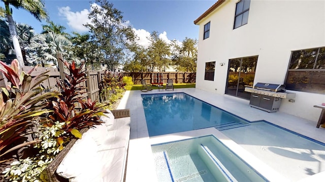 view of swimming pool with an in ground hot tub and area for grilling