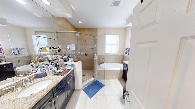 bathroom with tile patterned flooring, vanity, and plus walk in shower