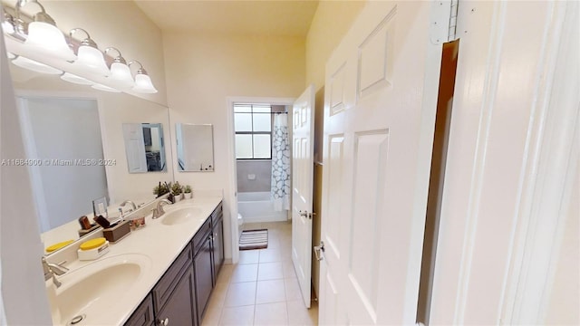 bathroom featuring tile patterned flooring, vanity, and  shower combination