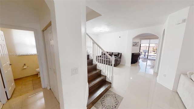 stairs with tile patterned floors