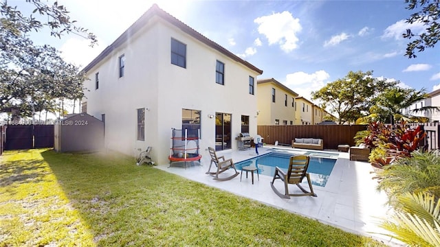 back of house featuring a patio area, a fenced in pool, an outdoor hangout area, and a yard