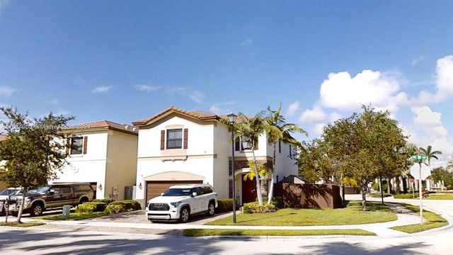 view of front of property featuring a garage and a front lawn