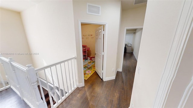 hallway with dark hardwood / wood-style flooring