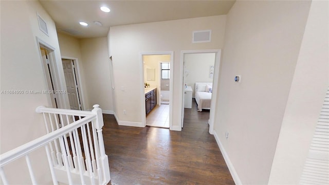 hallway with dark hardwood / wood-style flooring