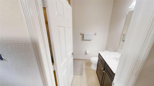 bathroom with tile patterned floors, vanity, and toilet