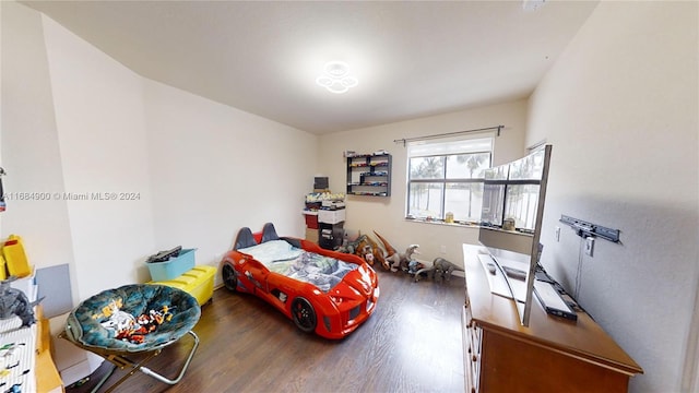 bedroom with hardwood / wood-style flooring