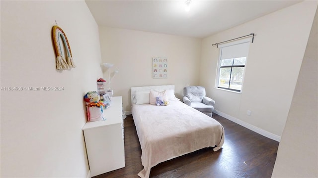 bedroom with dark hardwood / wood-style floors