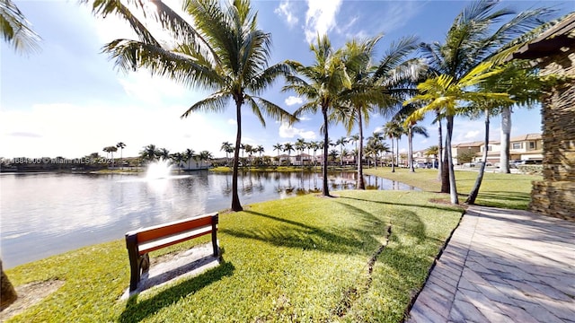 view of home's community featuring a water view and a yard