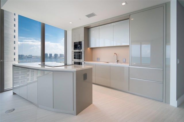 kitchen with a kitchen island, sink, and cooktop