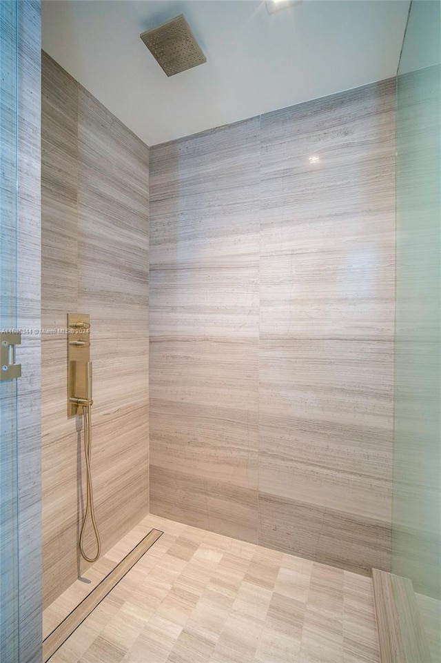 bathroom featuring tile walls and walk in shower