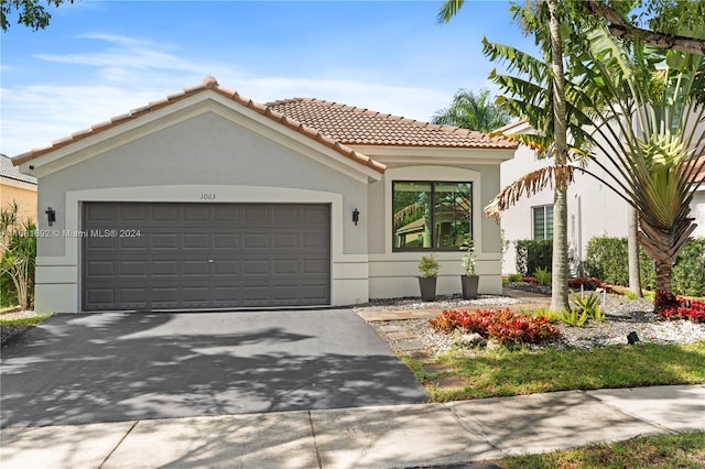 mediterranean / spanish house featuring a garage