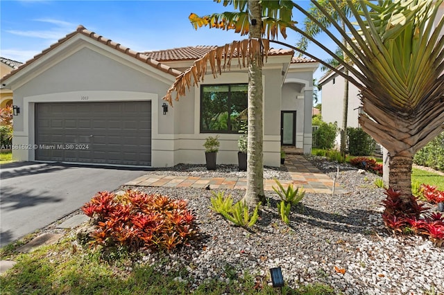 mediterranean / spanish house featuring a garage