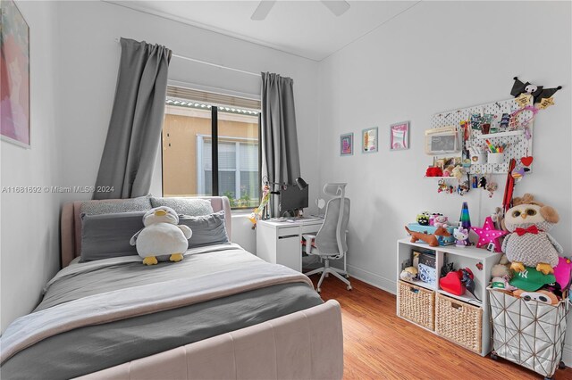 bedroom with ceiling fan and light hardwood / wood-style floors