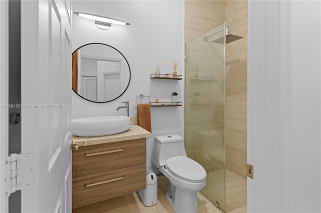 bathroom with vanity, tile patterned floors, toilet, and an enclosed shower