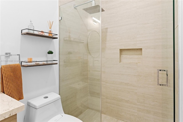 bathroom featuring vanity, toilet, and a shower with shower door