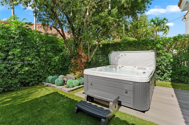 view of yard featuring a hot tub and a wooden deck