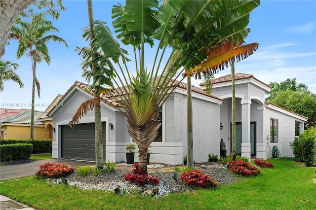 view of front facade with a front yard and a garage