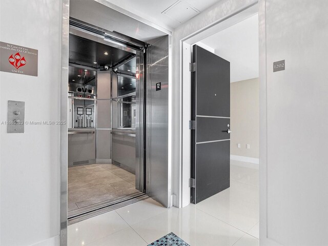 bathroom with tile patterned floors and elevator