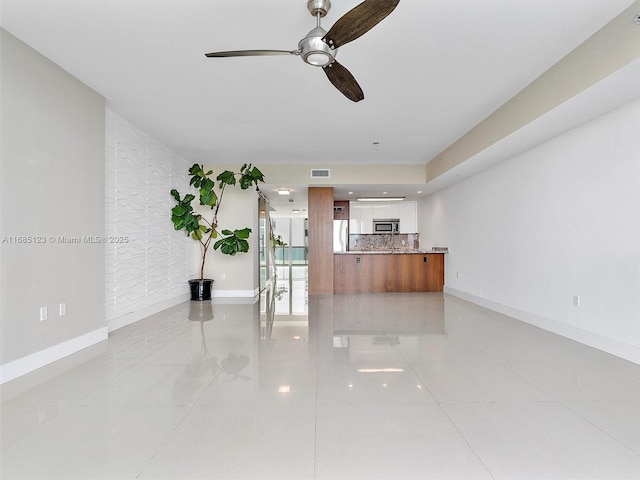 unfurnished living room with light tile patterned floors and ceiling fan