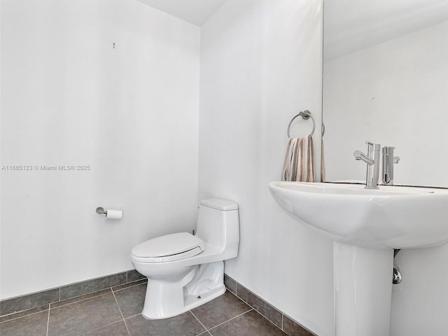 bathroom featuring tile patterned flooring and toilet