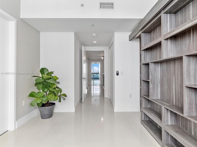 hall with light tile patterned flooring