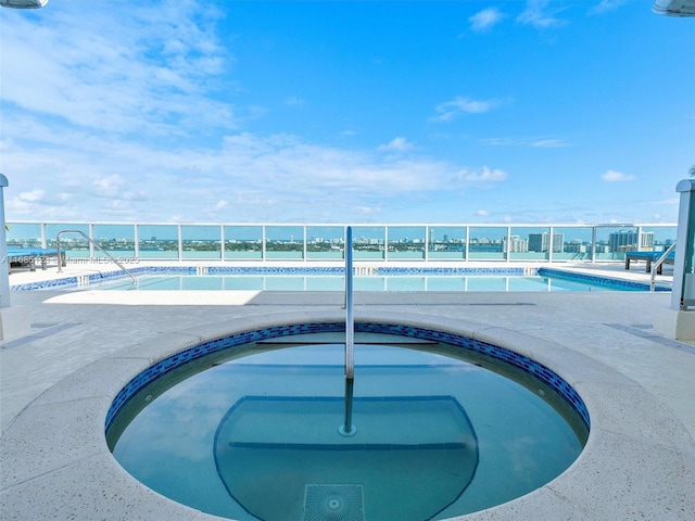 view of pool with a hot tub