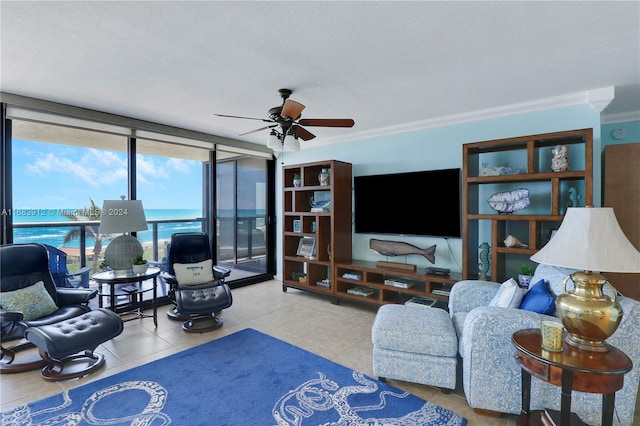 living room featuring floor to ceiling windows, crown molding, light tile patterned flooring, a textured ceiling, and ceiling fan