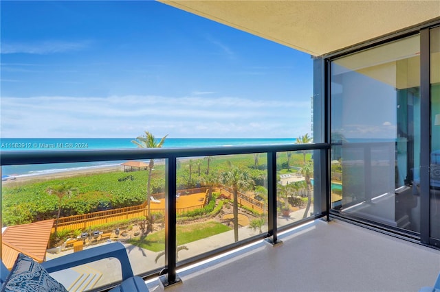 balcony with a water view and a beach view