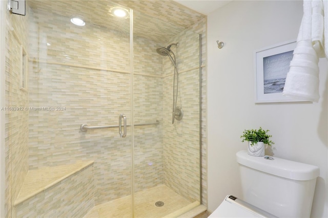 bathroom with toilet and walk in shower