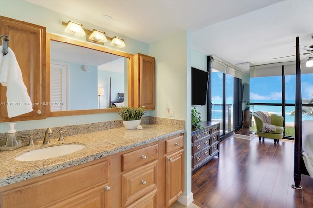 bathroom featuring vanity, hardwood / wood-style floors, ceiling fan, and floor to ceiling windows