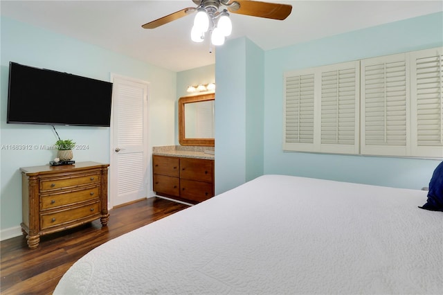 bedroom featuring ensuite bathroom, dark hardwood / wood-style floors, and ceiling fan