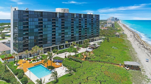 birds eye view of property with a beach view and a water view